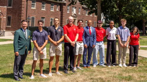Rutgers Evans Scholars and officials in the courtyard behind the Liberty National NJSGA Evans Scholars Scholarship House (previously known as Jameson Residence Hall D on the Rutgers Douglass campus) include, at left, John Kaczkowski, president and CEO of the Western Golf Association/Evans Scholars Foundation; fourth from left, Kenneth Maher, a senior and president of the Rutgers Chapters of the Evans Scholars; and sixth from left, Rutgers Provost and Executive Vice Chancellor Jason Geary. Photo by John O’Bo