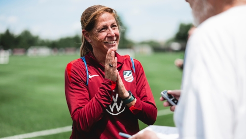 US Women's Soccer Team Coach talks to a report during practice