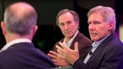 Peter Seligmann AG’72, center, with Harrison Ford, at right, in 2013. Photo by Stuart Isett/Fortune Brainstorm Green.