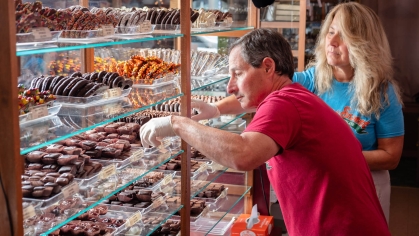 Michael and Jennifer Schnur stocking shelves of their store Thomas Sweet.