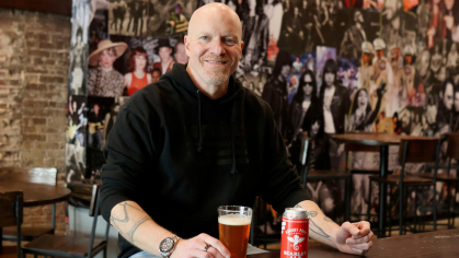 Bob McLynn LC '94, with Scarlet Ale, a beer his brewery created.