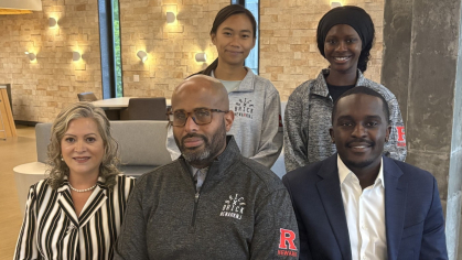 Seated center, Clayton Walton, executive director of the Rutgers–Newark Office of Globally Engaged Experiential Learning, with global ambassadors Virginia De Pascual, left, Jason Towindo, right. Graduate Coordinator Carina Bontia is standing left, with Olivia Tutu in the lounge at John Cotton Dana Library. Photo by Allison Freeman.
