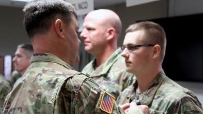 At right, Daylen Osmer, who was a private first class in the U.S. Army in 2018, receiving the Army Achievement Award.