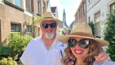 Man and women in sunglasses and sun hats smiling