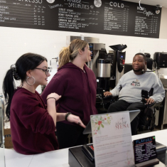 Baristas Olivia Rajewski, left, and Carly Kovach, center, with LeGrand at his coffee shop