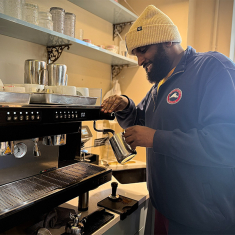 Omar Bareento prepares a coffee for a customer at Qaalii’’s Café.