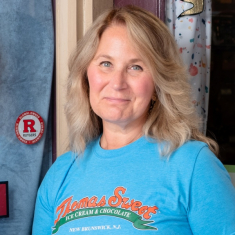 Logo stickers—like the one pictured next to alumna Jennifer Schnurr—are available for alumni-owned businesses who register for the directory.