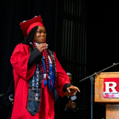 Gichera Loman crossing the commencement stage. Photo by Ron Downes Jr.